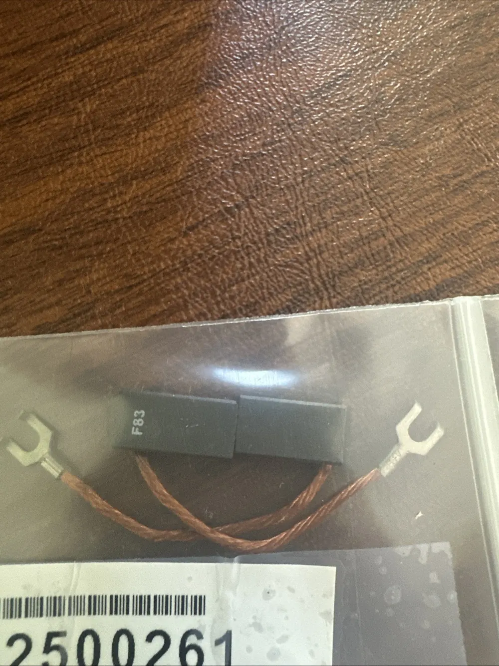 Bodine F83 motor brush with pigtail leads, sealed in a labelled bag